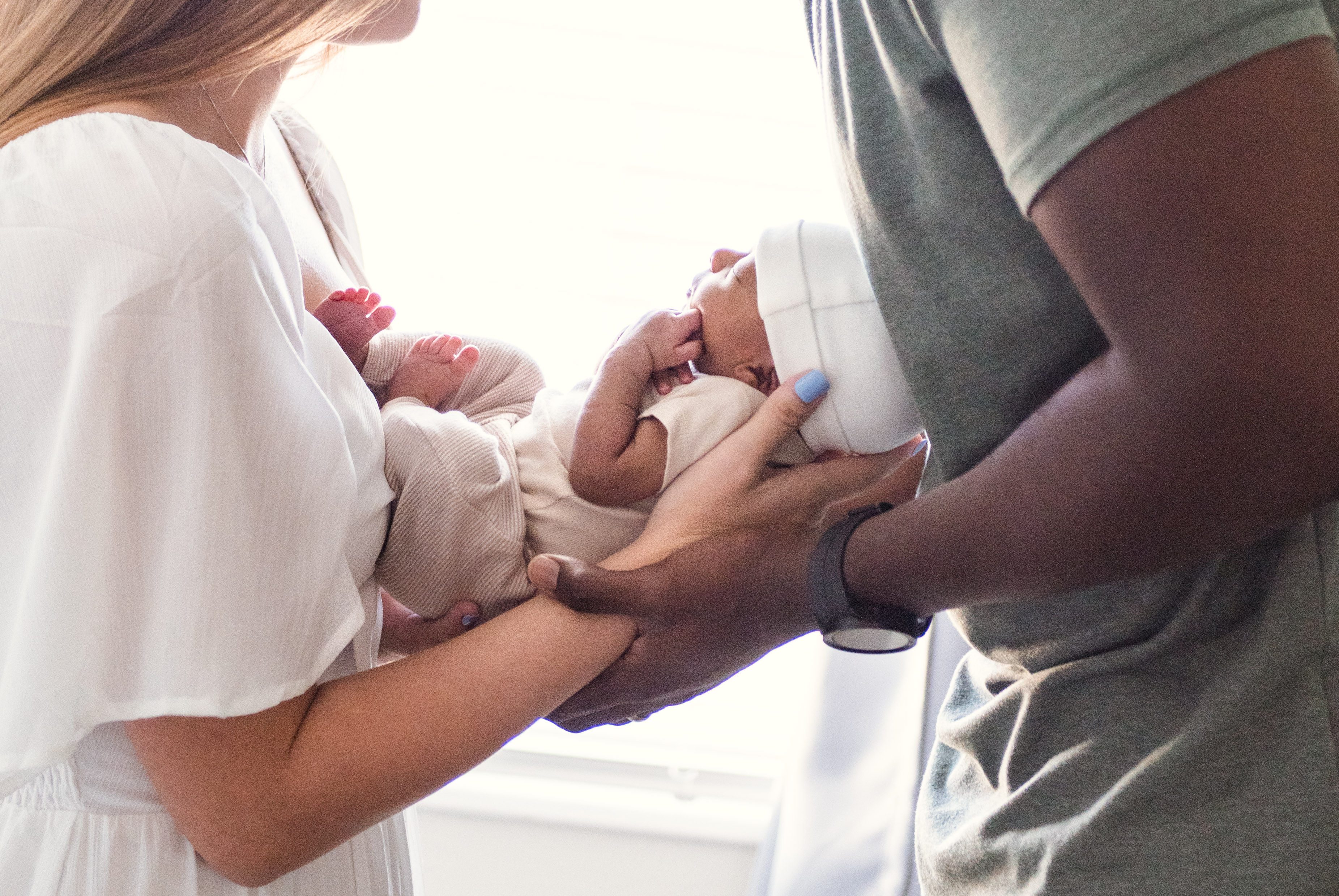 A newborn baby wrapped in a white blanket